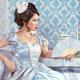 Beautiful asian woman sitting with a fan... (thumbnail)