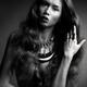Beautiful woman with long hair wearing jewelry black and white photo... (thumbnail)