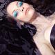 Beautiful woman with blue makeup lying in water... (thumbnail)