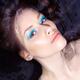 Sensual beauty portrait of a woman with blue makeup lying in water... (thumbnail)