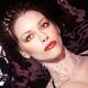 Woman wearing makeup and red lipstick lying in water... (thumbnail)