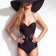 Beautiful woman wearing a trendy one-piece swimsuit and a sunhat... (thumbnail)