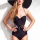 Beautiful woman wearing a one-piece swimsuit and a sun hat... (thumbnail)