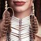 Closeup of woman wearing aboriginal necklace and feathers... (thumbnail)