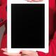 Woman in red business suit holding iPad... (thumbnail)