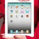 Woman in red business suit holding iPad in her hands... (thumbnail)