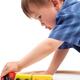 Boy plaing with a toy railroad... (thumbnail)