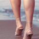 Legs of a woman wearing high heel shoes at the beach... (thumbnail)