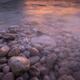 Sunset reflecting in water of a rocky shore... (thumbnail)
