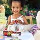 Smiling young girl having a party outdoors... (thumbnail)