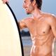 Young man with a surfboard enjoying himself... (thumbnail)