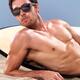 Surfer in sunglasses lying on the beach... (thumbnail)