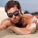 Portrait of a young man in sunshades lying on sand... (thumbnail)