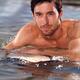 Portrait of a man with surfboard in water... (thumbnail)