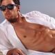 Sexy young man lying on sand at the beach... (thumbnail)