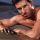 Portrait of a man lying on a sea shore... (thumbnail)