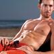 Suntanned young man at the beach... (thumbnail)