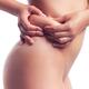 Woman pinching fat around her waist... (thumbnail)