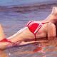 Glamorous young woman in bikini lying in water... (thumbnail)