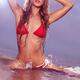 Young woman in red bikini posing in water... (thumbnail)