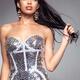 Young woman in shiny dress holding hair in her hand... (thumbnail)