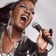 Black woman singing in microphone... (thumbnail)
