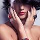 Beauty portrait of a woman wearing jewelry with red stones... (thumbnail)