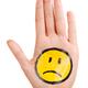 Hand with a sad smiley face icon on it... (thumbnail)