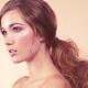 Beauty portrait of a young woman with long red hair in a ponytail... (thumbnail)