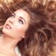 Beautiful young woman with long brown hair spread around her... (thumbnail)