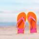 Colorful orange flip flops in sand at the beach... (thumbnail)