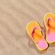 Orange flip flops on beach sand... (thumbnail)