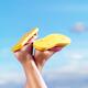 Legs of woman in yellow flip flops... (thumbnail)