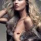 Beauty portrait of woman with blond hair wearing fur vest over bare bo... (thumbnail)