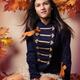 Teenage girl surrounded with autumn leaves... (thumbnail)