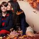 Teenage girl kissing a boy artistic fall fashion photo