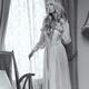 Beautiful blond woman in night gown by the window Black and white... (thumbnail)