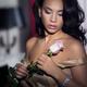 Romantic portrait of young woman with rose in hands... (thumbnail)