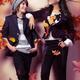 Fashionably dressed boy and teenage girl under falling autumn leaves... (thumbnail)