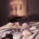 Handcuffs ropes and rose petals on bed BDSM sex romantic concept... (thumbnail)