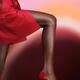 Black woman leg in sexy red high heel shoe... (thumbnail)