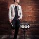Portrait of a drummer standing at a wall... (thumbnail)