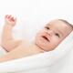 Cute smiling baby boy cuddling in towel... (thumbnail)