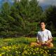 Person meditating in summer nature during sunrise... (thumbnail)