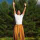 Man practicing sunrise Qi Gong meditation... (thumbnail)