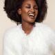 Beautiful smiling black african american woman wearing white fur... (thumbnail)