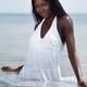Beautiful black woman in dress standing in water... (thumbnail)