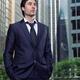 Portrait of business man with office buildings behind him... (thumbnail)