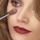 Woman face with makeup brush applying foundation... (thumbnail)
