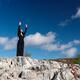 Young woman practicing sunrise Qi Gong... (thumbnail)